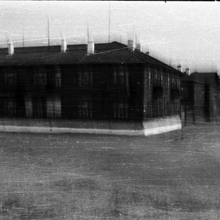 Black-and-white photo of a Soviet-era building with ice rink.