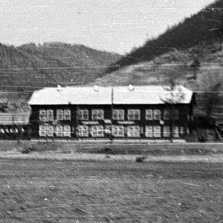 Rural mountain village with wooden buildings.