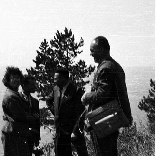 Group of five people outdoors in a natural setting.
