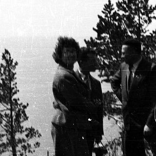 Group of five people outdoors in a natural setting.
