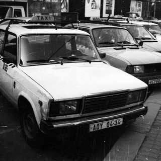 Taxi vehicles parked in a row.