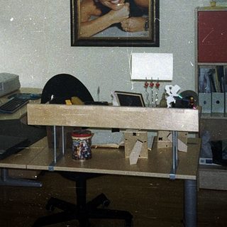 Vintage office cubicle with retro computer setup.