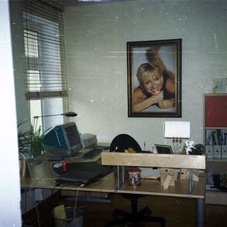 Vintage office cubicle with retro computer setup.