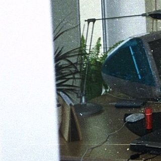 Vintage office cubicle with retro computer setup.
