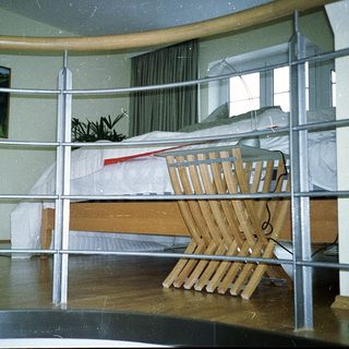 Child safety gate blocking bedroom doorway with crib inside.