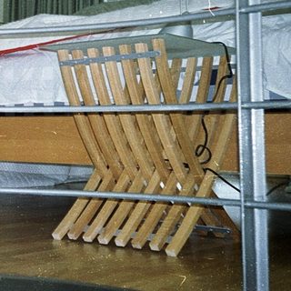 Child safety gate blocking bedroom doorway with crib inside.