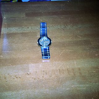 Vintage wristwatch on wooden surface.