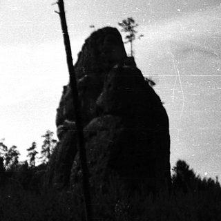 Rural landscape with rocky outcrops and forest.