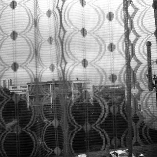 Distorted cityscape through patterned glass.