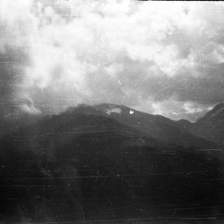 Dramatic storm clouds over mountainous terrain.