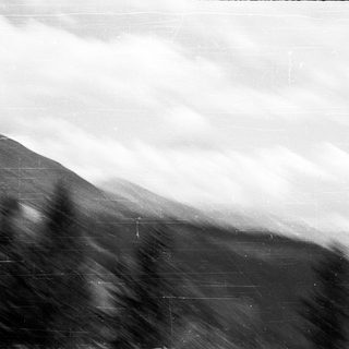 Volcanic landscape with dense smoke or ash.