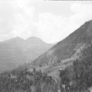 Mountainous landscape with forested slopes.