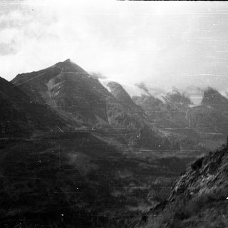 Majestic mountain range with misty peaks.