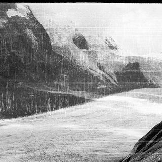 Snowy mountain landscape with falling snow.