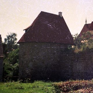Historic town with castle ruins and church tower.