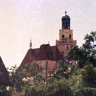 Historic town with castle ruins and church tower.