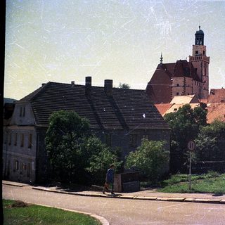 Historic town with castle ruins and traditional buildings.
