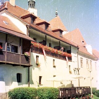 Charming European-style building with flower boxes and umbrellas.