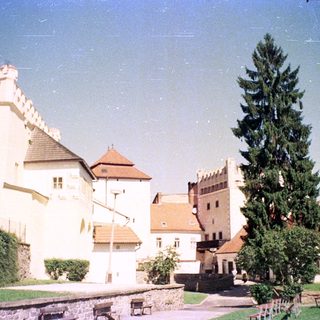 Medieval castle complex with fortified buildings and courtyard.