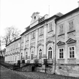 Neoclassical building with arched windows and balcony.