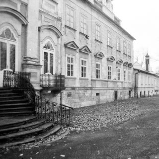 Neoclassical building exterior with stone steps.