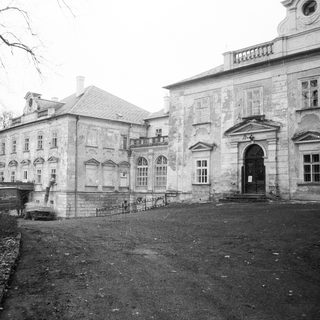 Neoclassical stone building with arched entrance.
