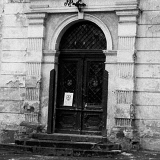 Classic stone building facade with arched entrance.