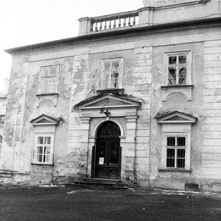Classic stone building facade with arched entrance.