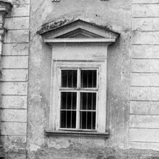 Classic stone building facade with arched entrance.