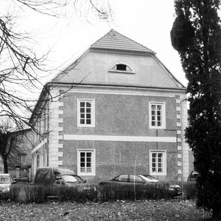 Two-story brick house with steep gable roof.