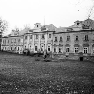 Elegant classical-style building in park-like setting.