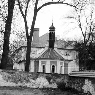 Historic church behind weathered stone wall.