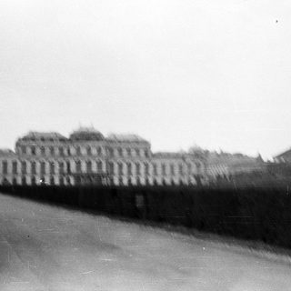 Blurred view of historic building with arched roof.