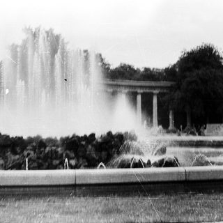 Majestic fountain with water jets in park setting.