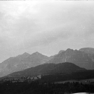 Mountainous landscape with cloudy sky.