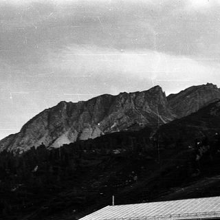 Majestic mountain range under cloudy sky.