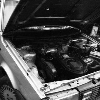 Open car hood revealing engine compartment.