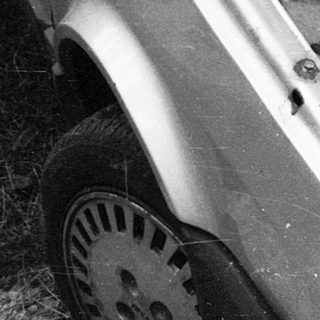 Open car hood revealing engine compartment.