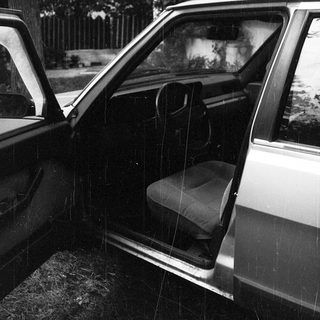 Open car door with visible interior seat.