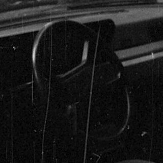 Open car door with visible interior seat.