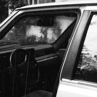 Open car door with visible interior seat.