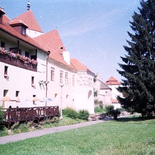 Charming historic building with flower boxes and greenery.