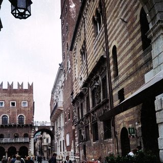 Historic European street with medieval buildings and outdoor café.