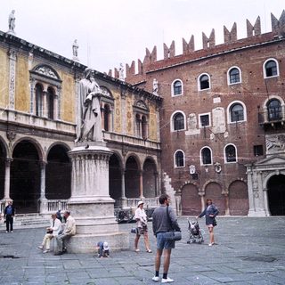 Historic square with Renaissance architecture and statue.
