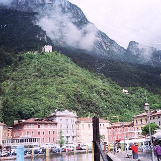 Scenic lakeside town nestled against mountainous backdrop.