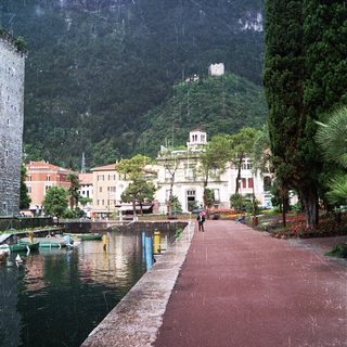 Scenic lakeside town with mountains, rain, and historic buildings.