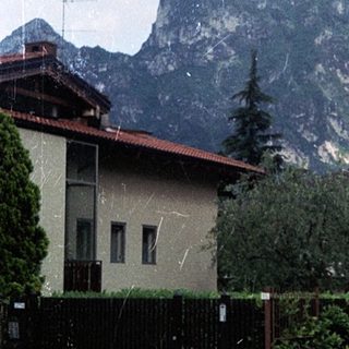 Mountain range behind residential area with rain.