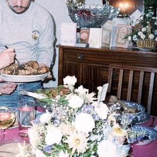 Family serving holiday meal together indoors.