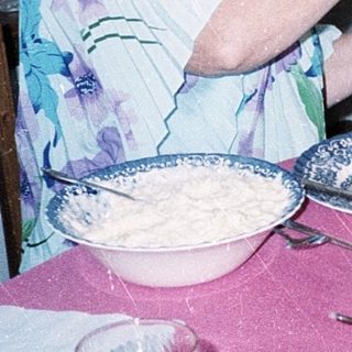 Family serving holiday meal together indoors.