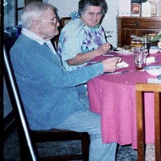 Family gathering enjoying meal indoors together.
